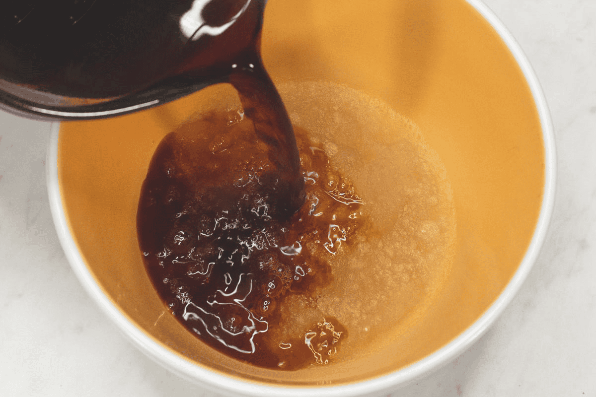 Pouring the hot coffee over the bloomed gelatin.