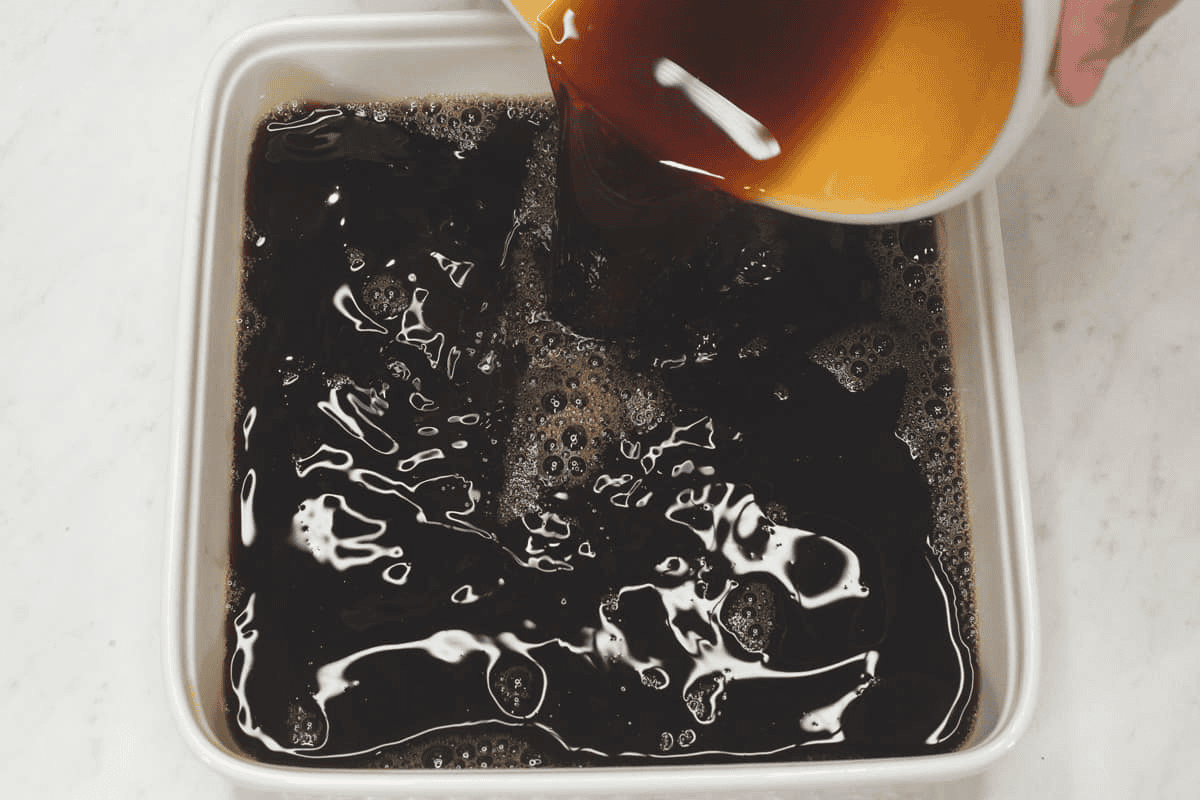 Pouring the jelly mixture to set in a shallow dish.