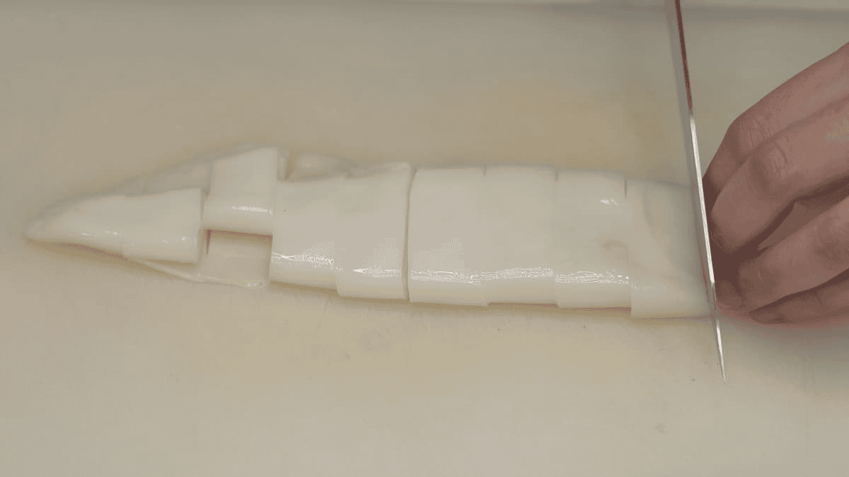 slicing squid tubes into rings.