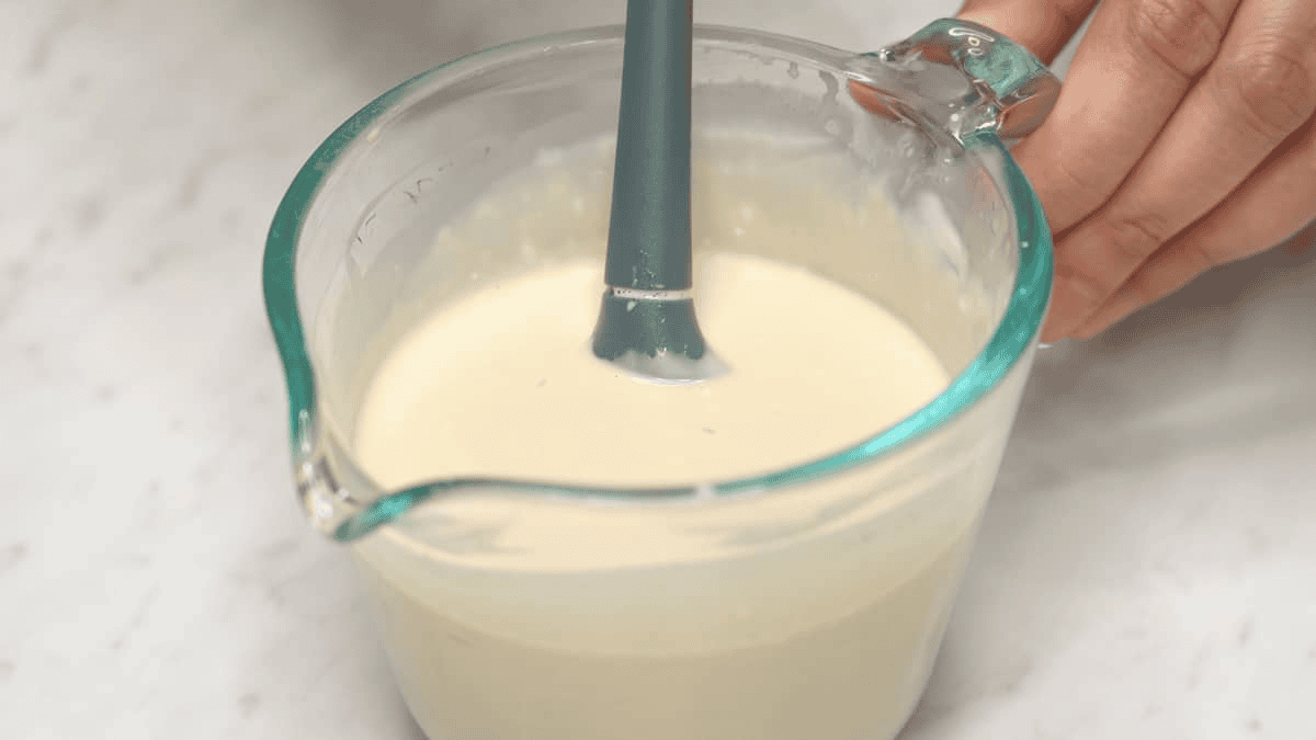 Mixing the sauce in a measuring cup.