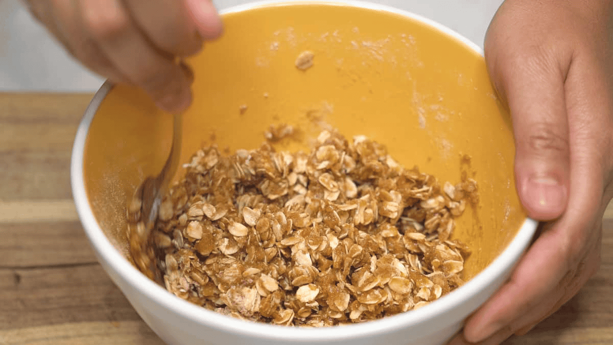 Mixing the oat streusel topping in the bowl with a fork.
