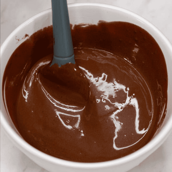 Mixing the chocolate dipping sauce until smooth.