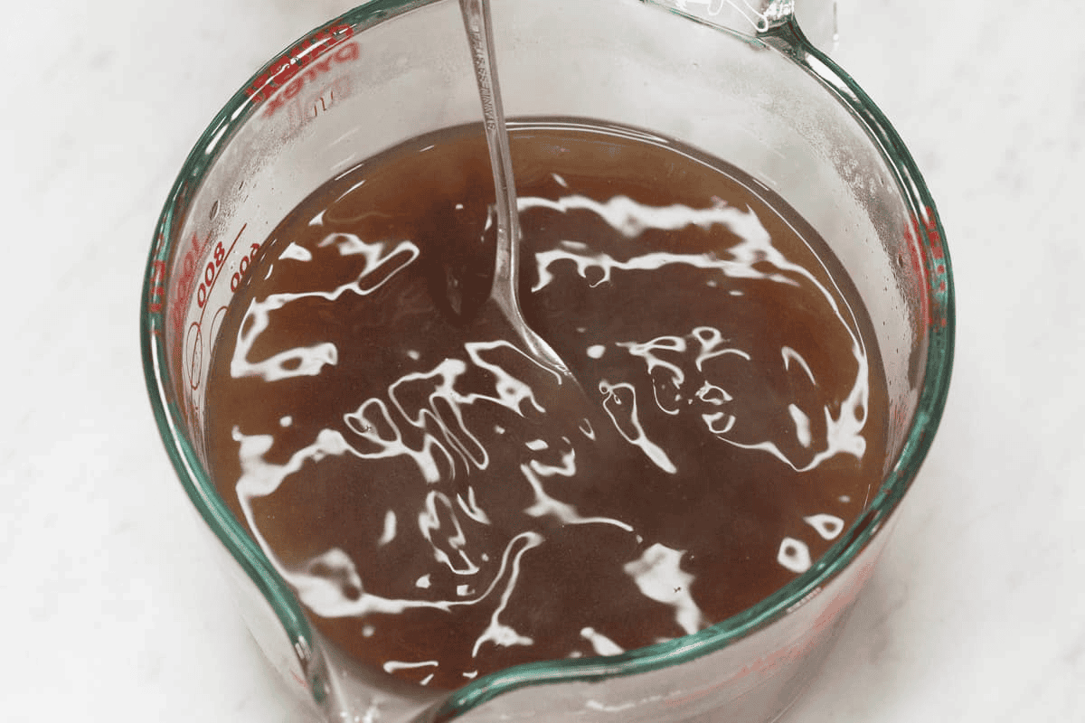Mixing the gravy mixture in a cup.