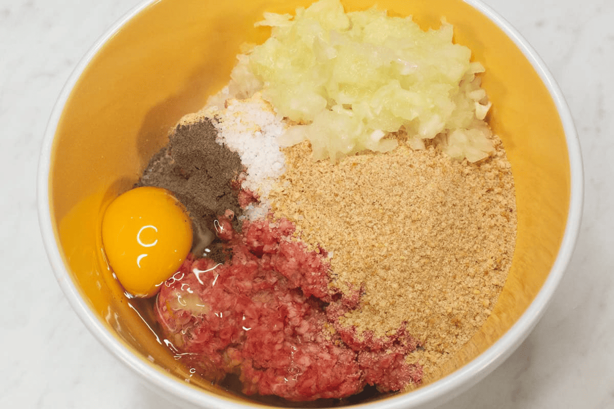 Combining the Burger Steak ingredients in a bowl.