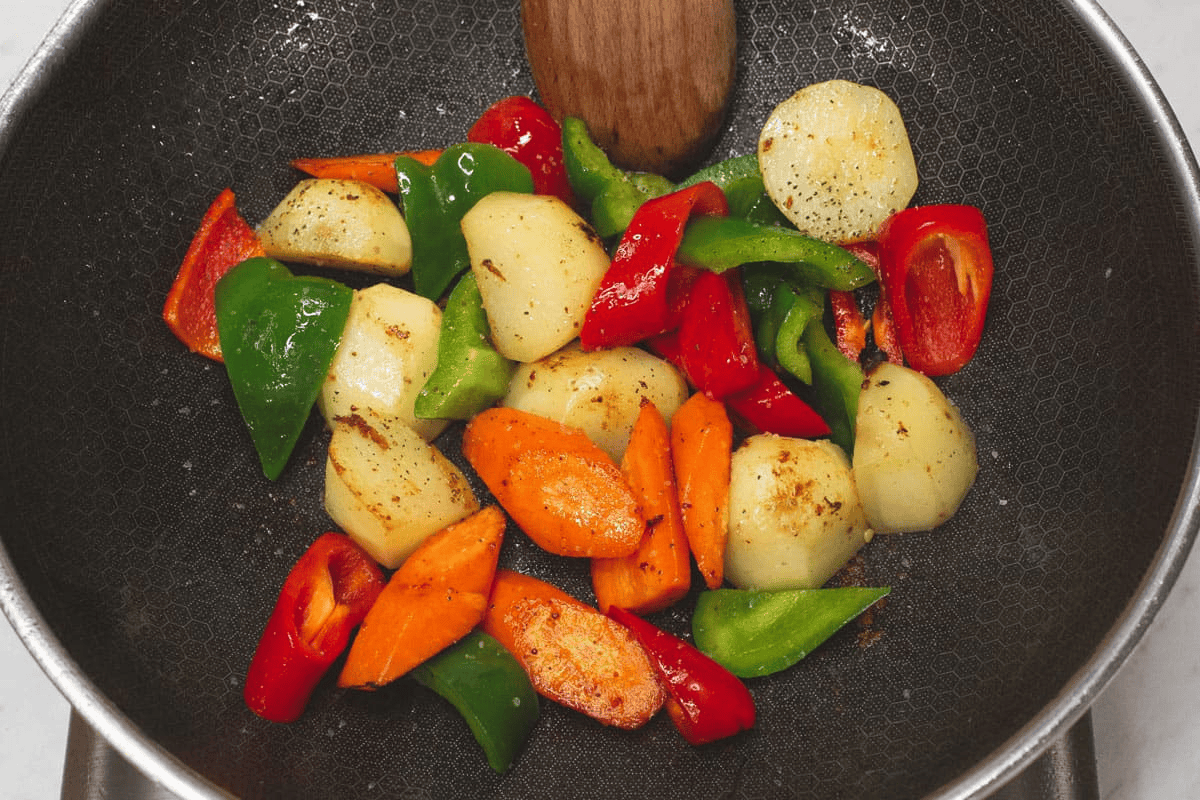 Searing the vegetables in the wok.