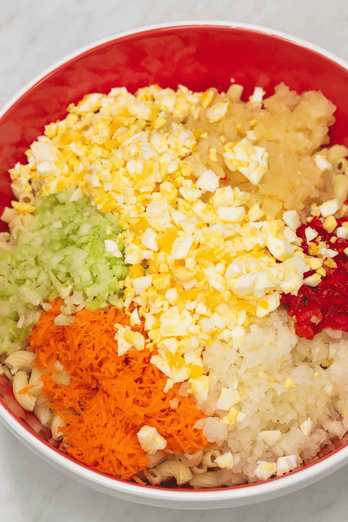 Macaroni with chopped ingredients in the bowl