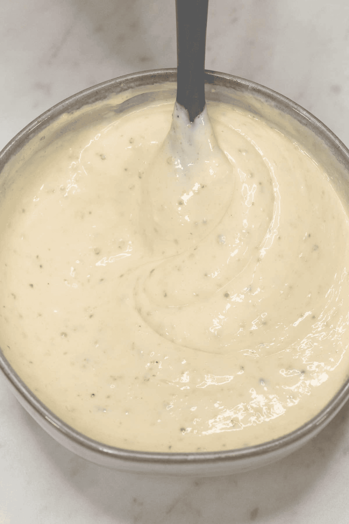 Mixing the dressing in the bowl.