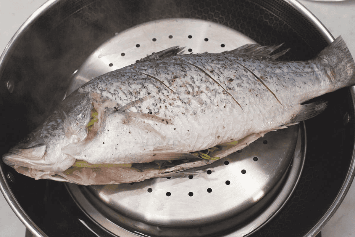 Steaming the fish on an improvised steamer.