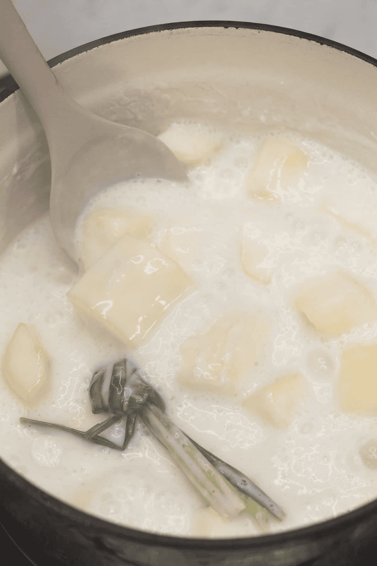 Boiling Ginataang Kamoteng Kahoy (Cassava with Coconut Milk) in the pot.