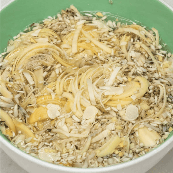 Sliced banana blossoms soaking in a bowl of water.