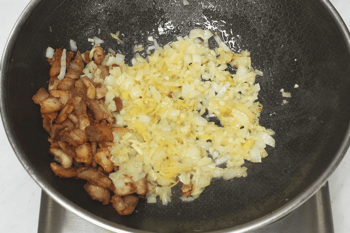Sauteing aromatics in a wok.