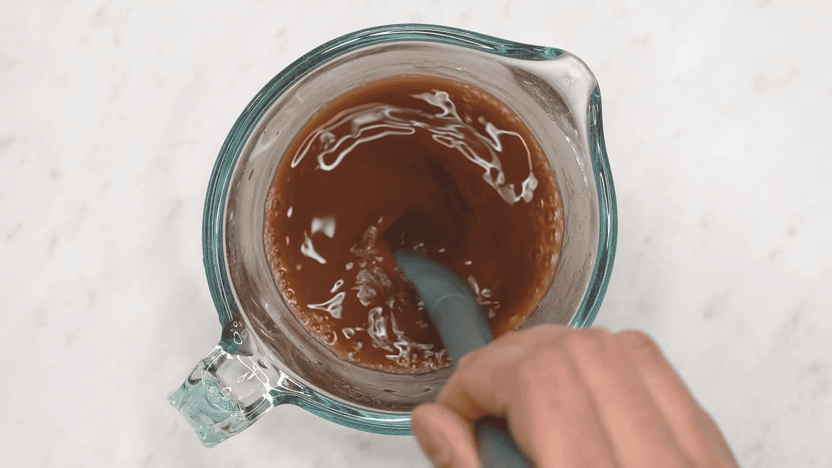Mixing the sauce ingredients in a cup.