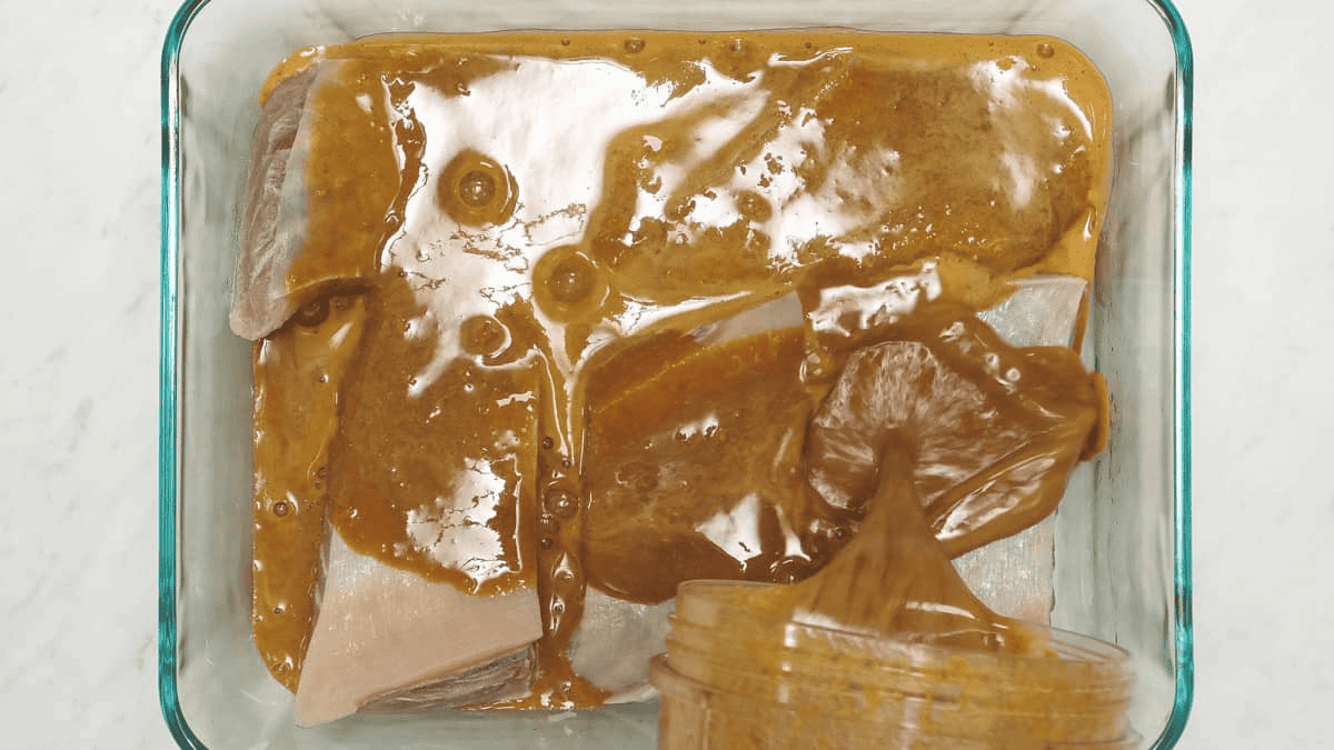 Marinating the tuna belly slices.