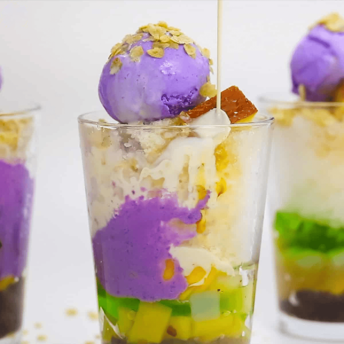 Drizzling milk to the Halo Halo in the glass.