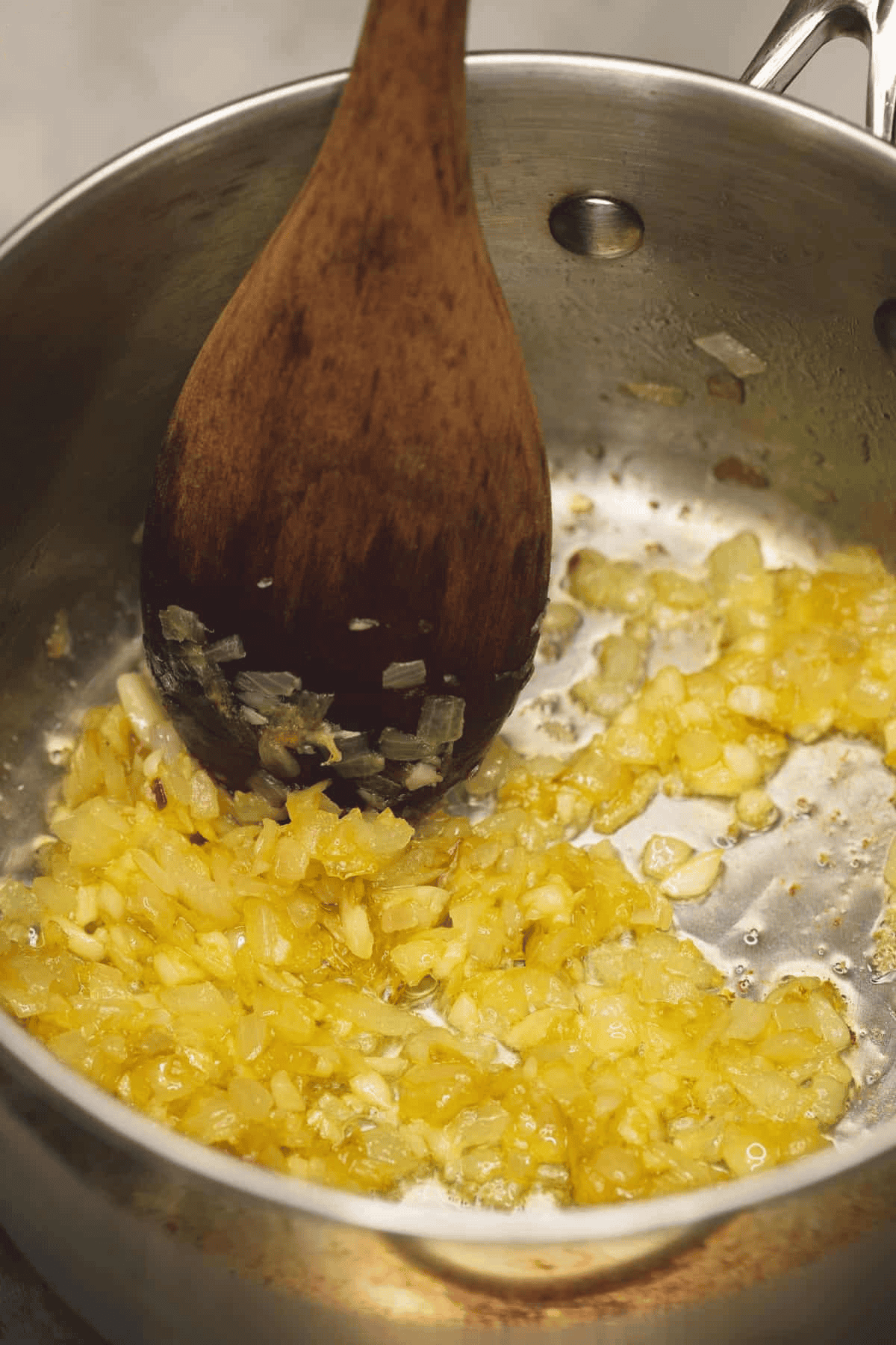 Sauteing onions and garlic in a saucepan.