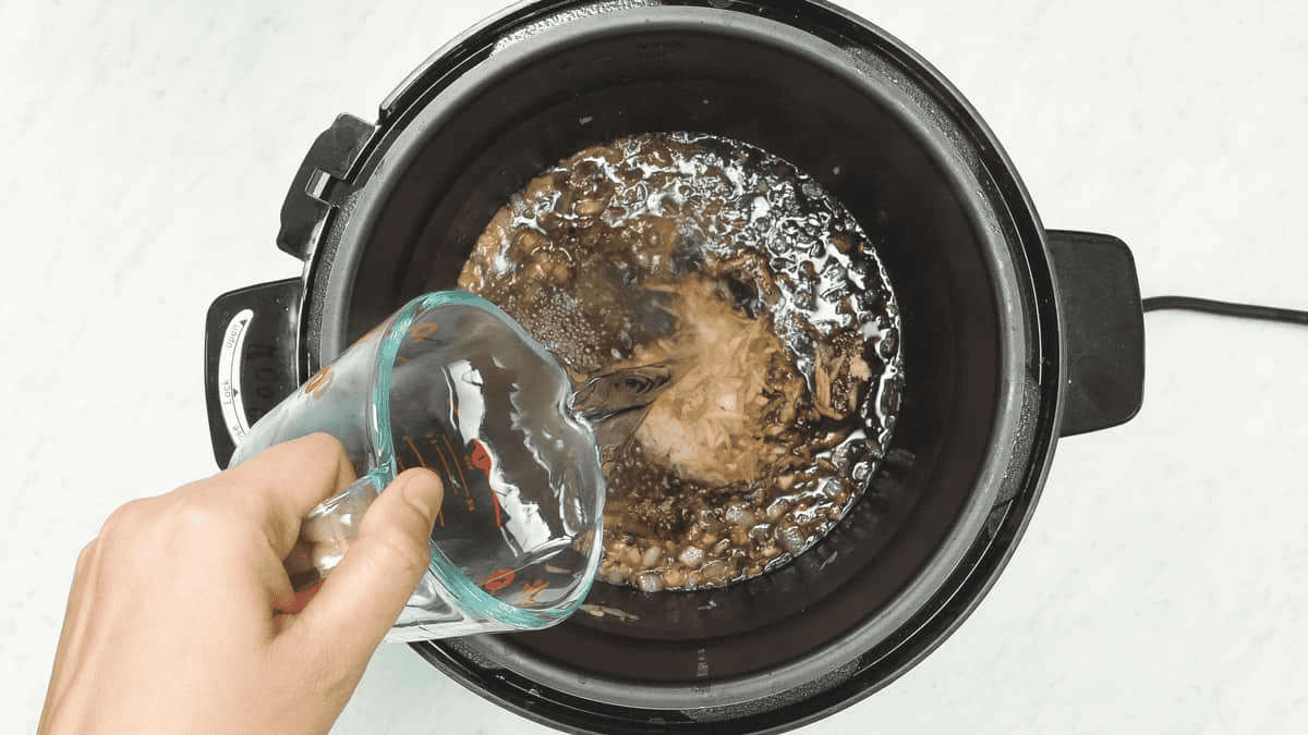 Pouring water into the pot.