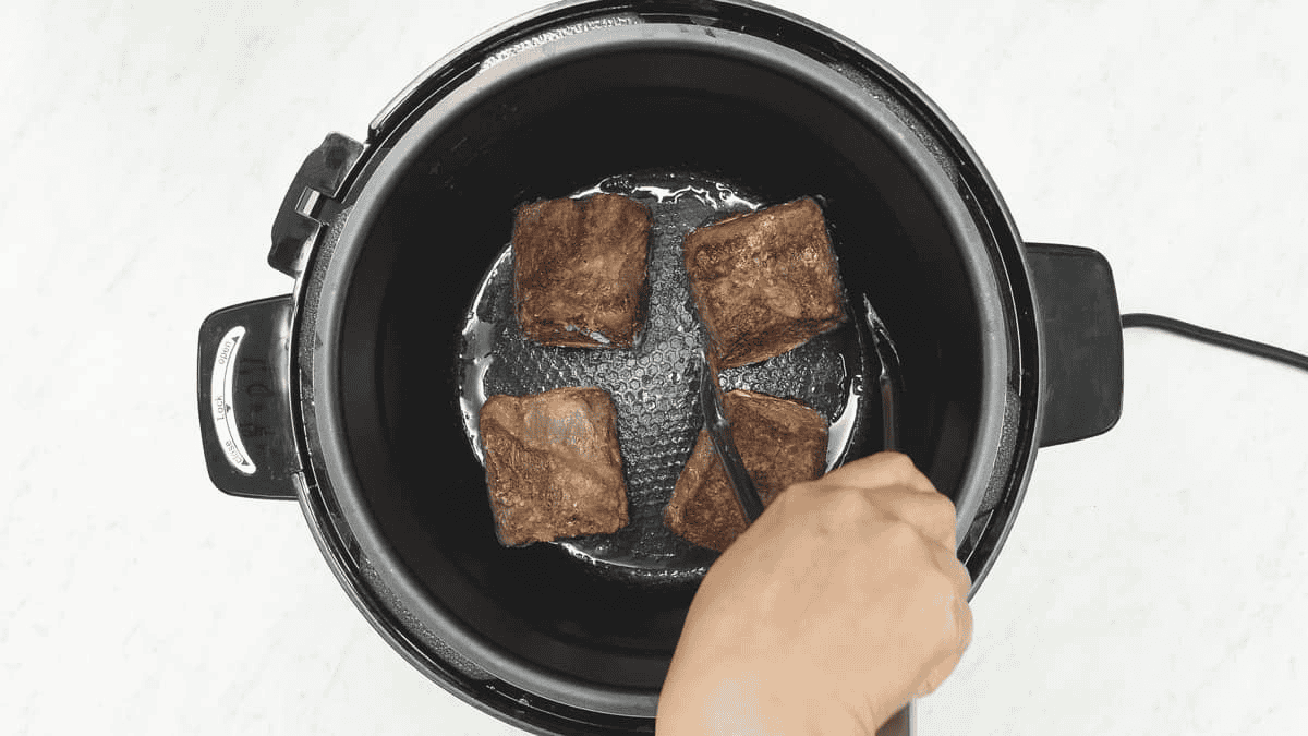 Searing the meat in an electric pressure cooker.