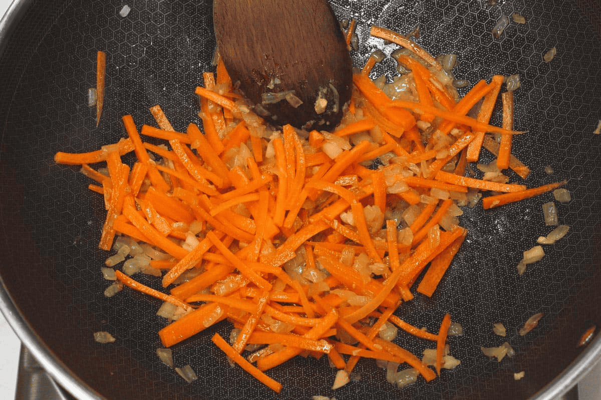 Sauteing the carrots in the wok.