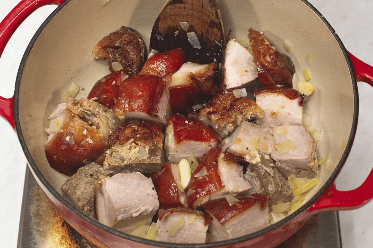 Sauteing the meat and aromatics in the pot.