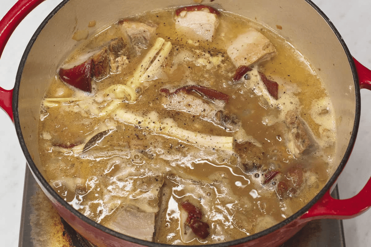 Simmering Lechon Paksiw in the pot.