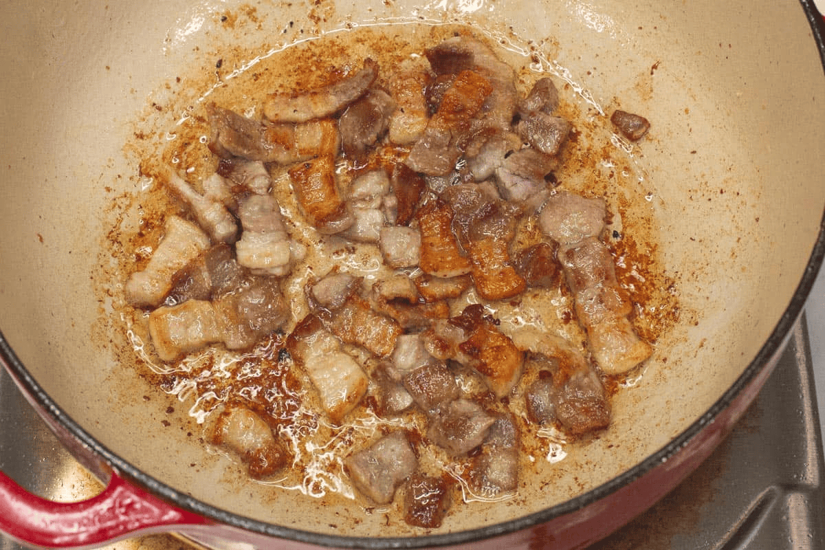 Browning the pork in the pot.