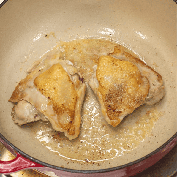 Searing chicken in a pot.