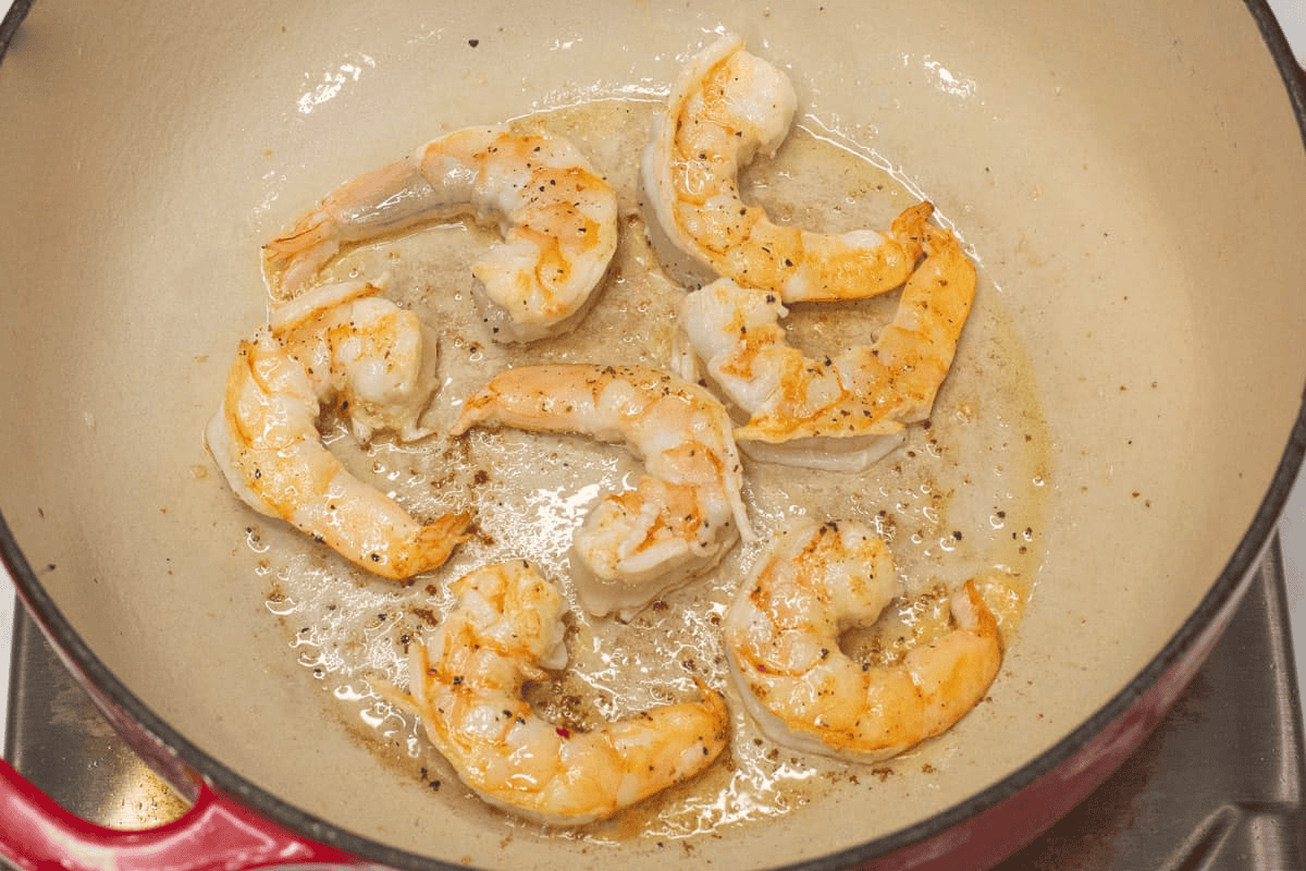 Searing the shrimp in the pot.