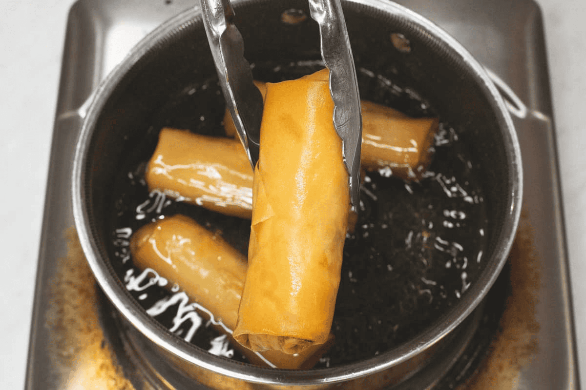 Frying Lumpiang Labong in the saucepan.