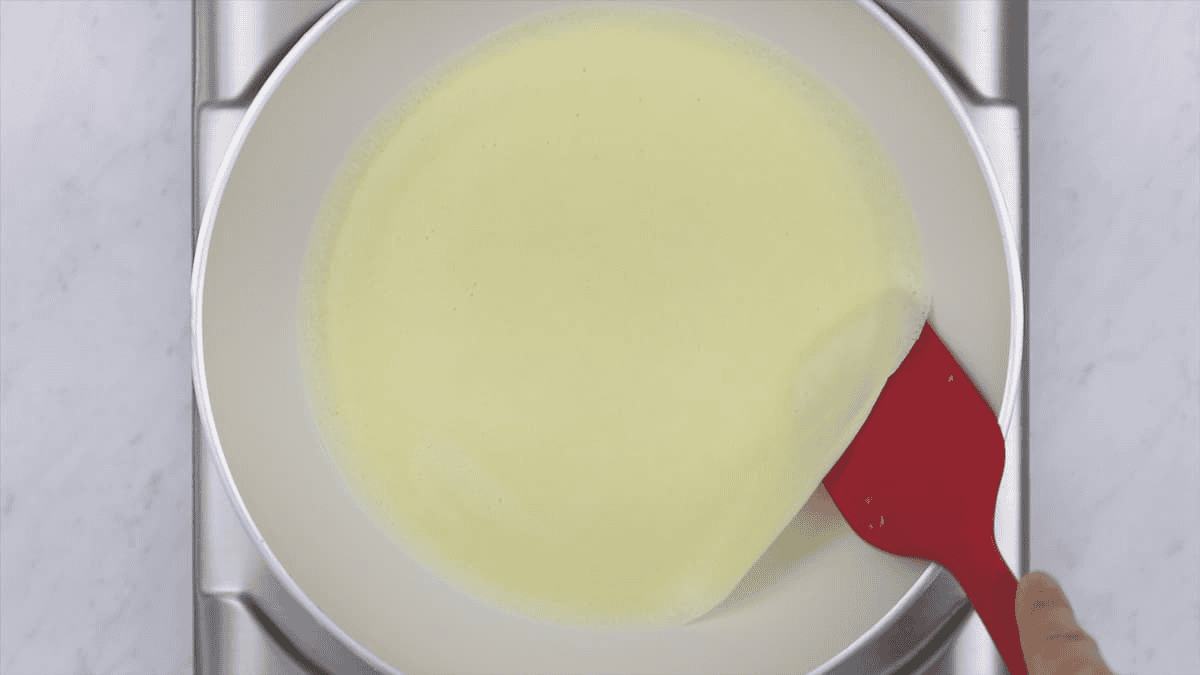 Lifting the sides of the crepe with a spatula.