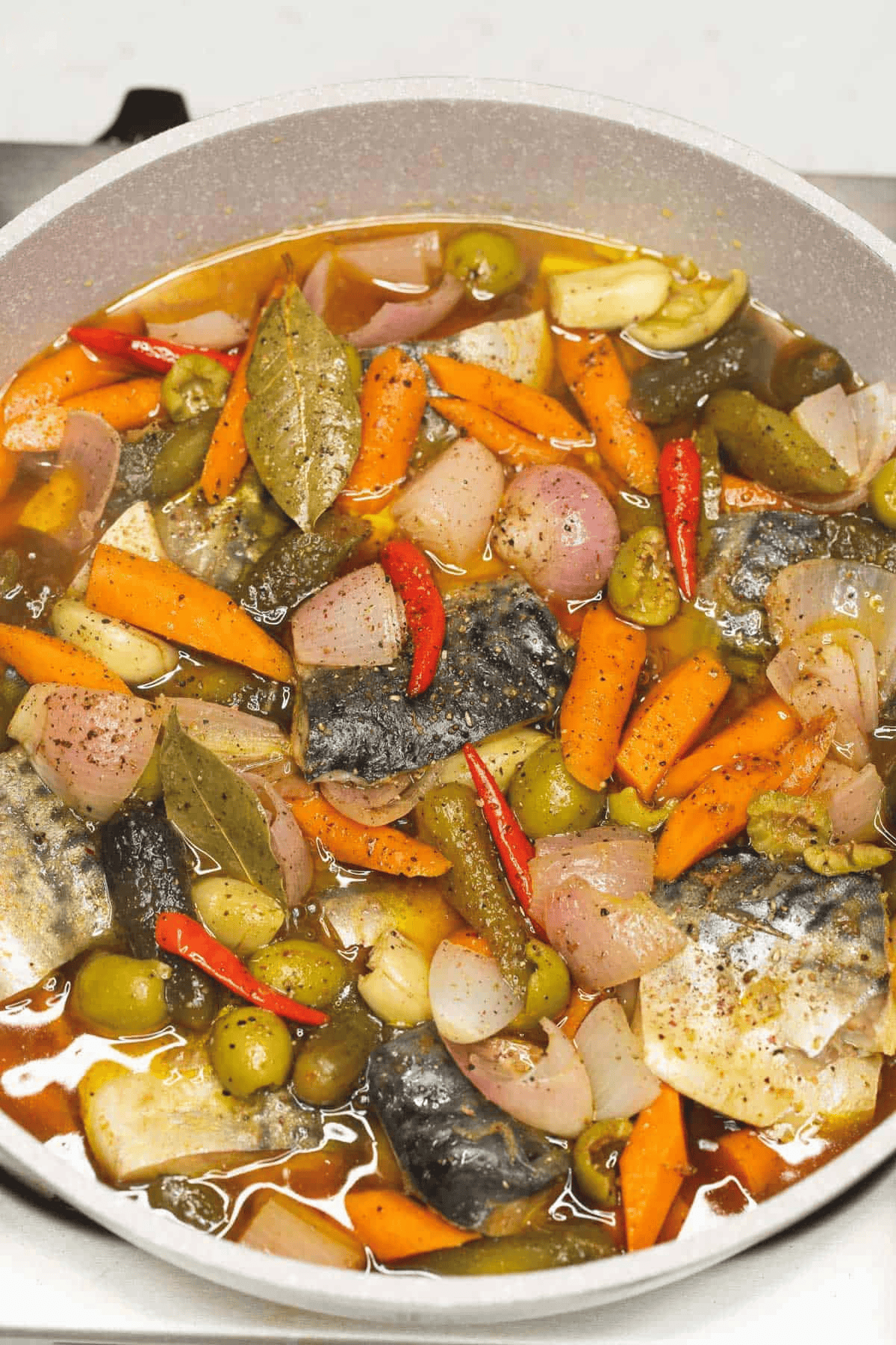 Cooked Mackerel in Olive Oil in the pan.
