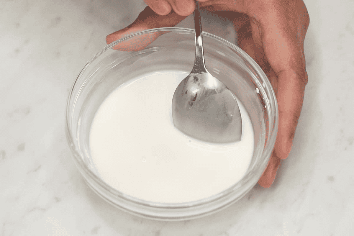 Dissolving the cornstarch in water to make a slurry.