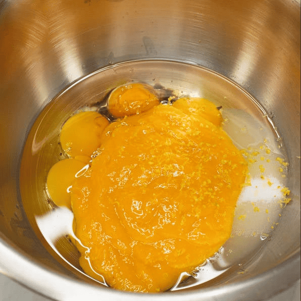 Combining the wet ingredients for mango cake.