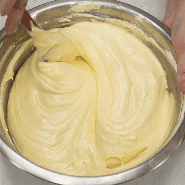 Light mango cake batter after folding in the meringue.