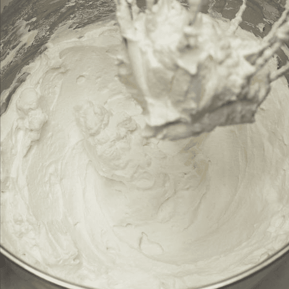 Whipped cream frosting after beating to firm peaks.