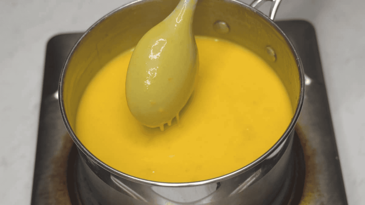 Thickened ice cream mixture, coating the back of the spoon.
