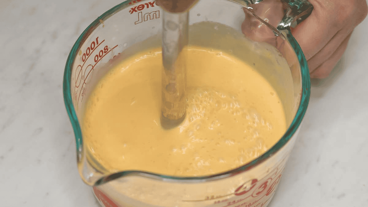Blending the cream mixture until smooth.