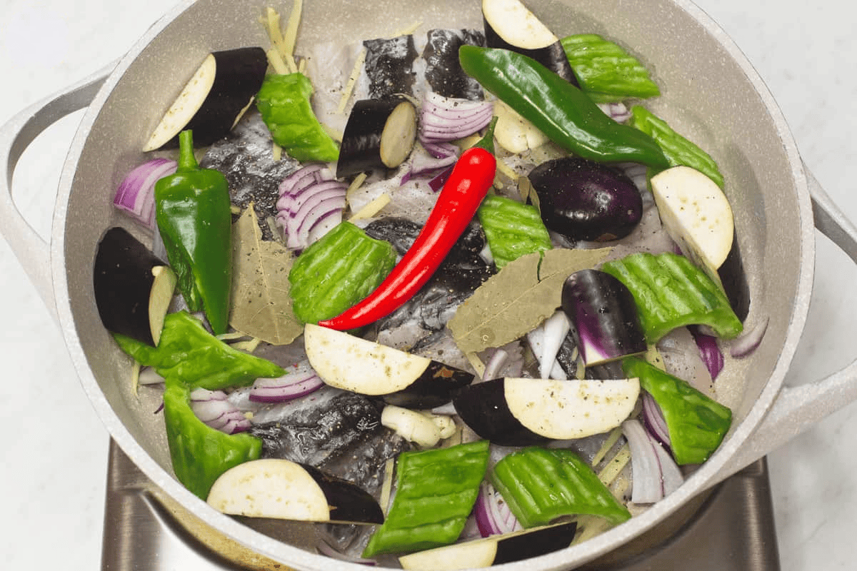 Placed the bangus and other ingredients in the saute pan.