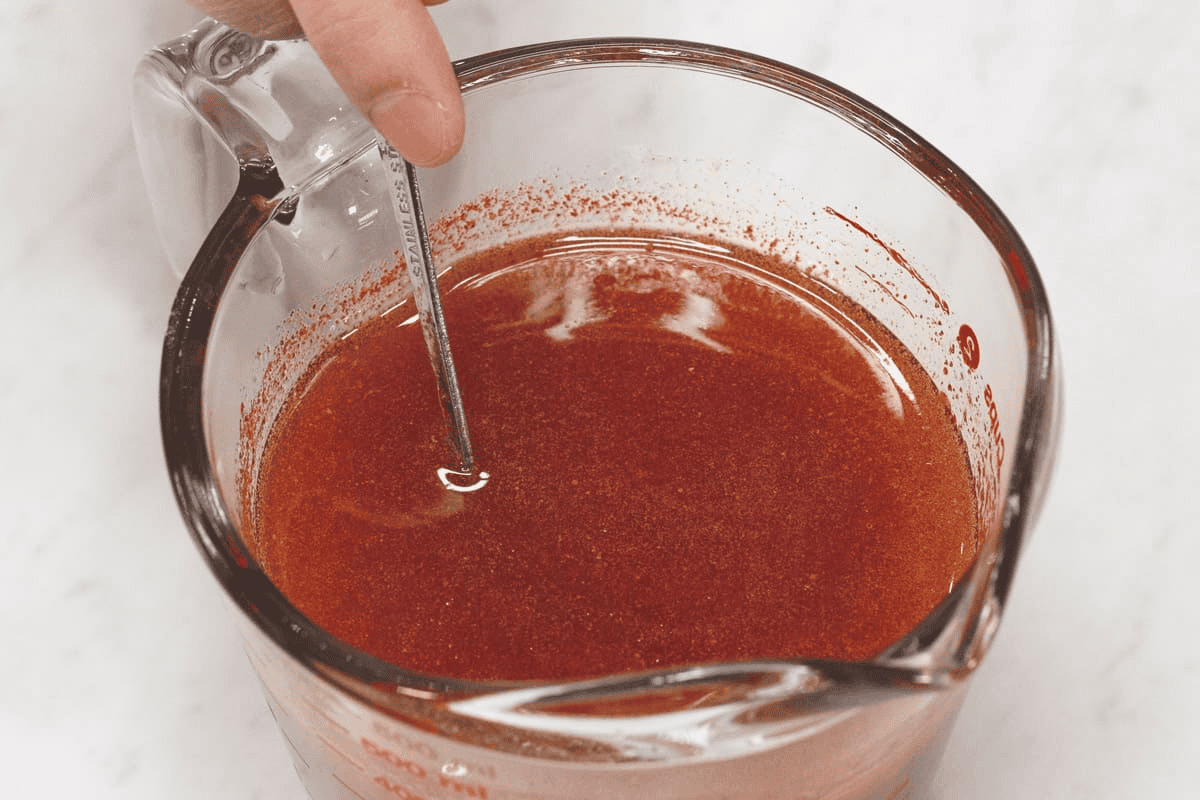 Mixing the sauce in a cup.