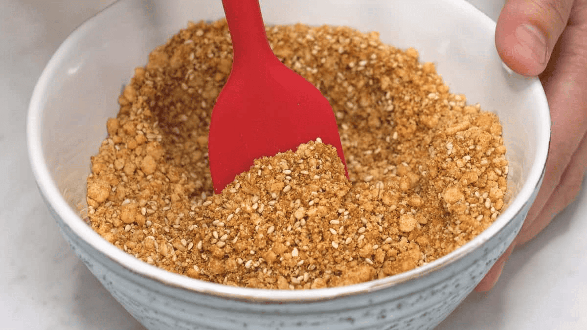 Mixing the sugar mixture in a bowl using a rubber spatula.