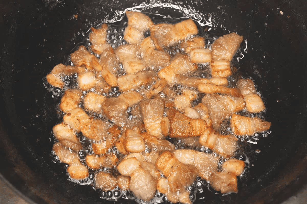 Browning the pork in the wok.