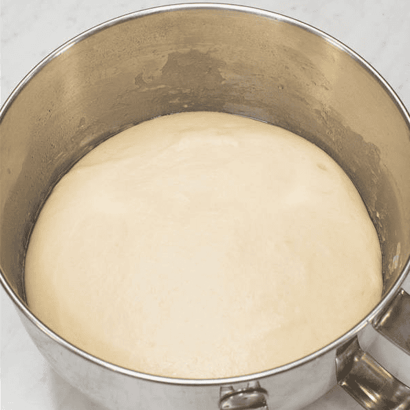 Dough after rising in a bowl.
