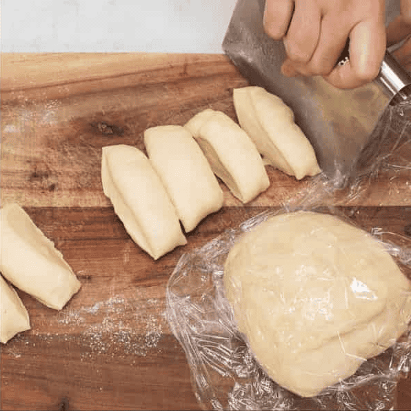 Cutting dough into portions.