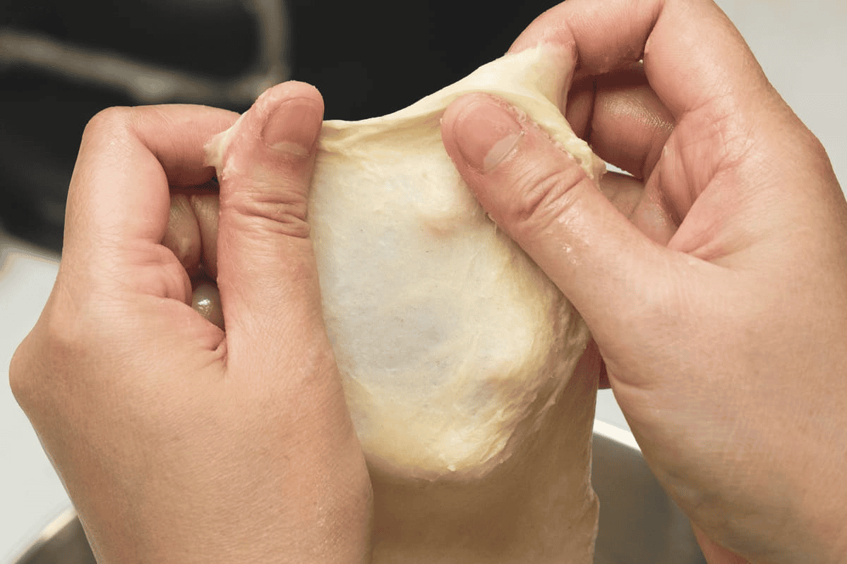 Doing the windowpane test on the dough.