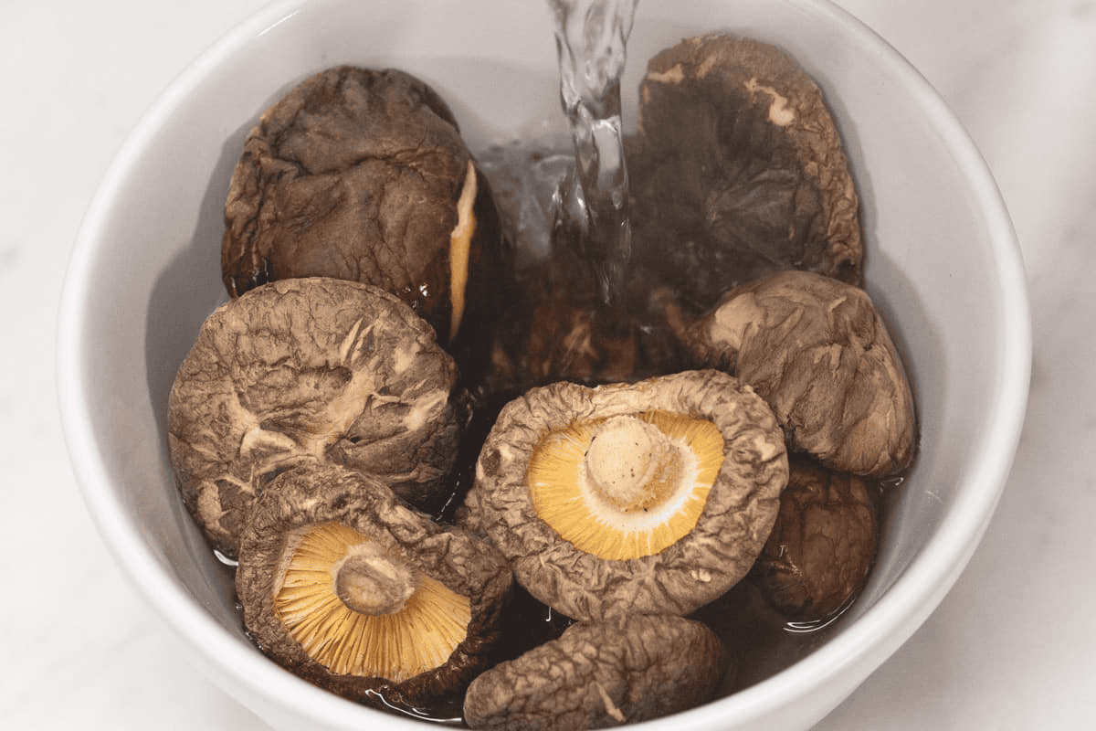 Rehydrating the shiitake mushrooms in a bowl.