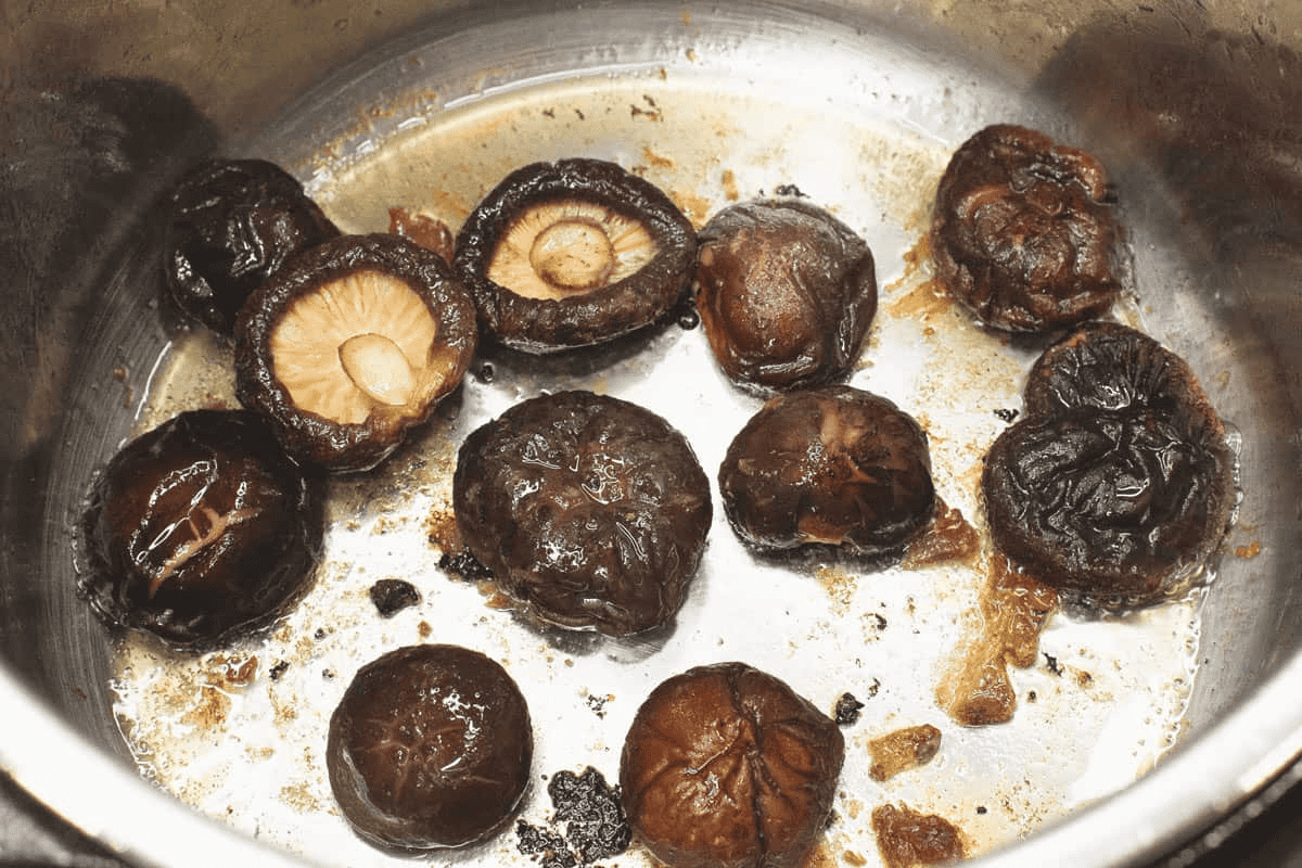 Sauteing the shiitake mushrooms in the pot.