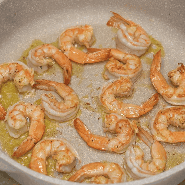 Searing shrimp in a pot.