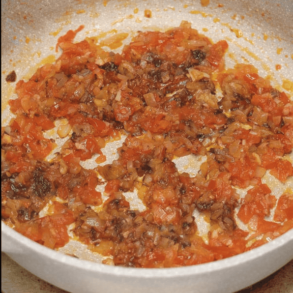 Sauteing chopped aromatics with shrimp paste.
