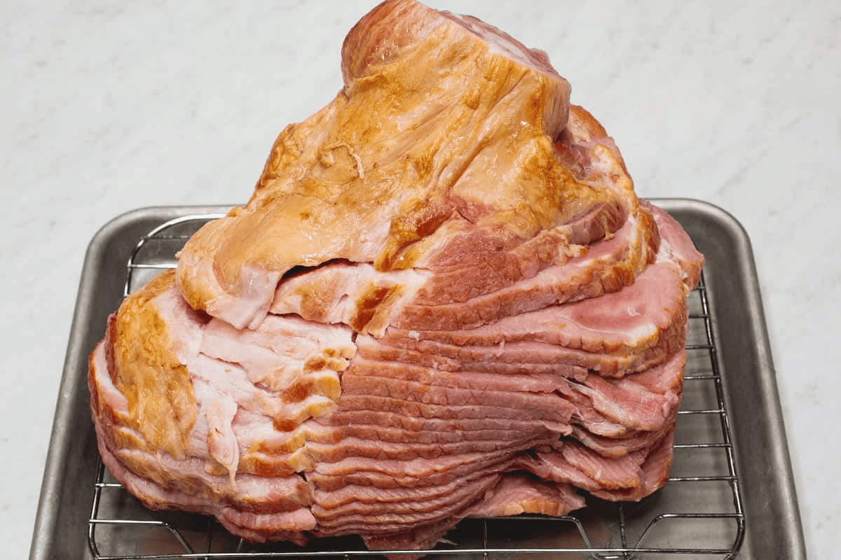 Draining the pre-cooked ham on a wire rack.