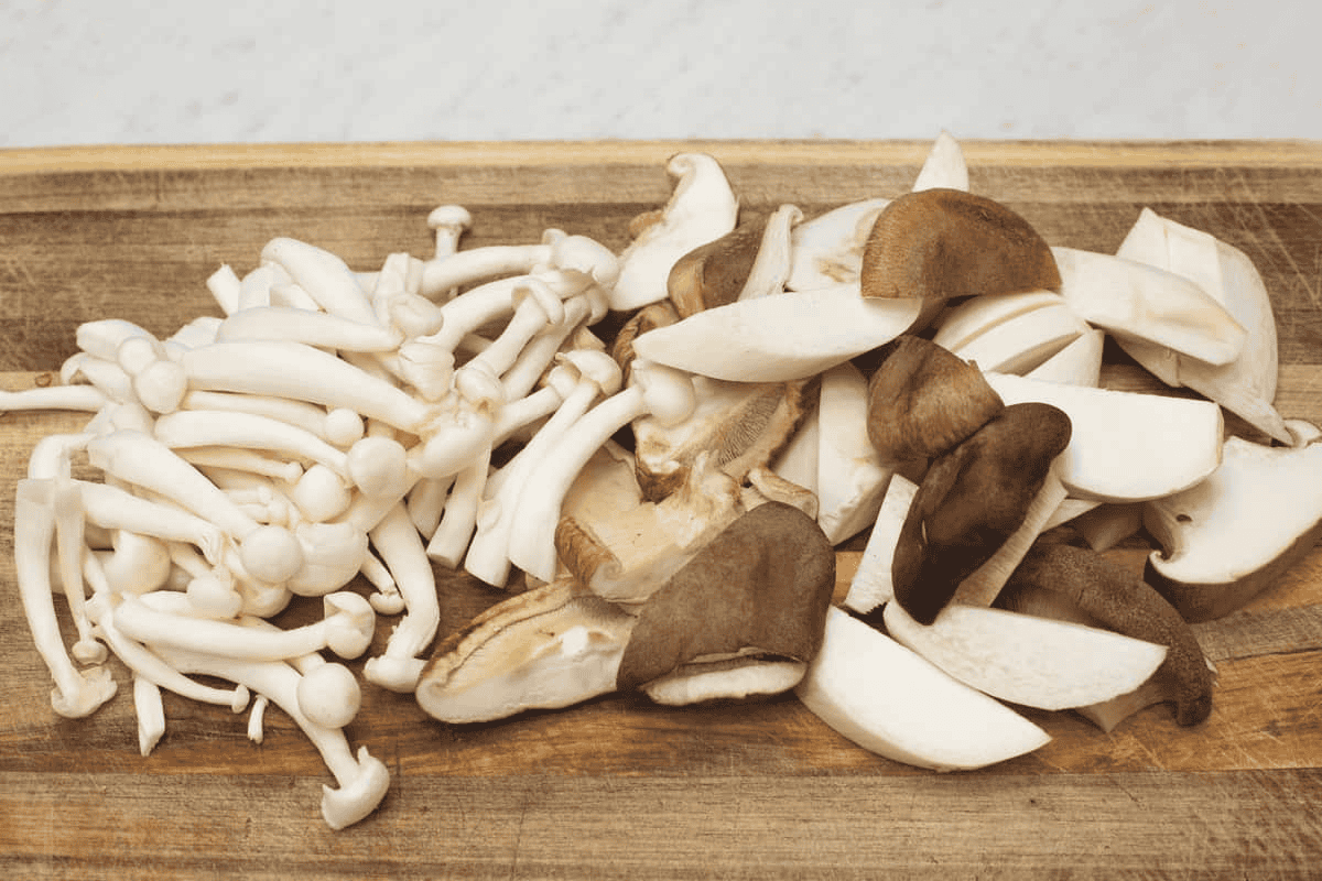 Assortment of mushrooms on a cutting board.