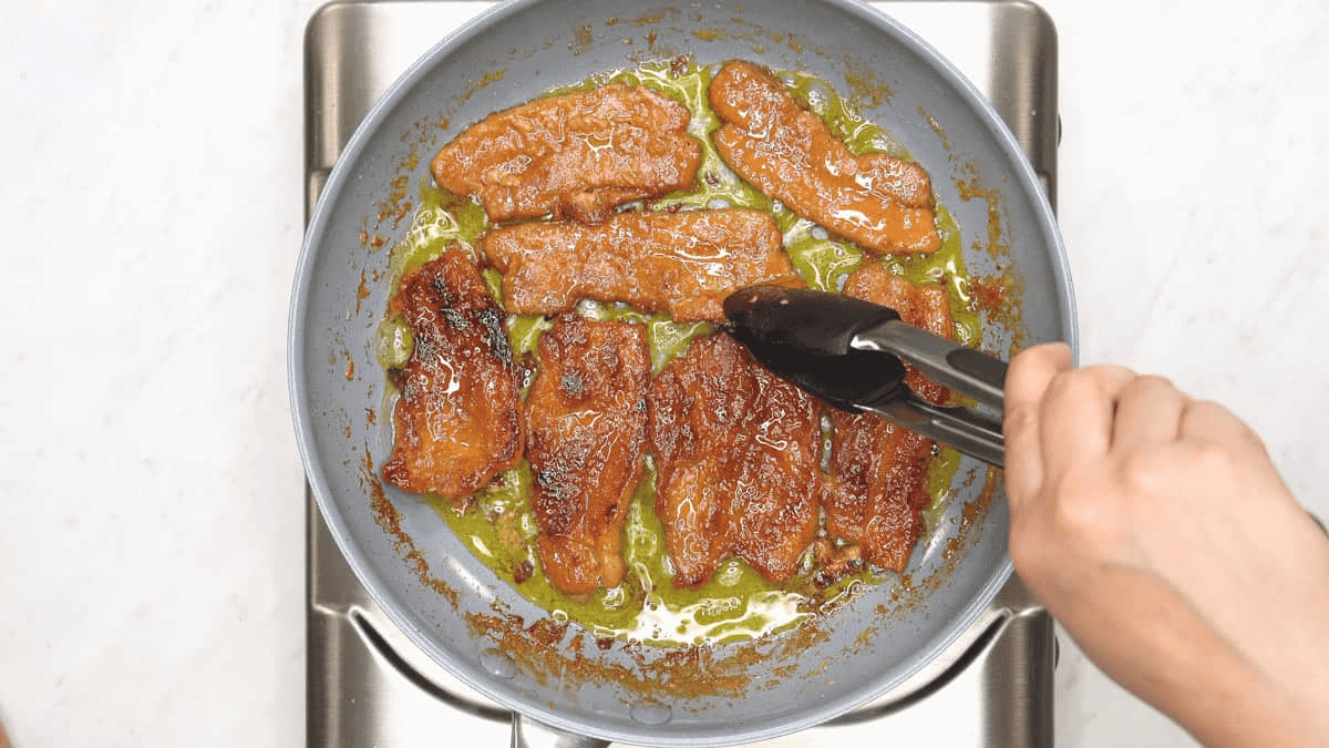Caramelizing the tocino in the skillet.